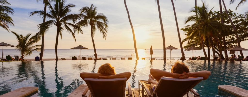 Beach,Travel,,Couple,Relaxing,On,Tropical,Beach,At,Sunset,In